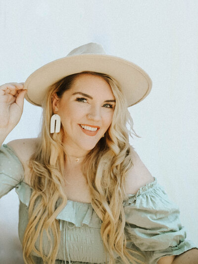 girl wearing a hat and smiling at camera