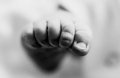 A close-up of a baby's foot in black and white, captured during a fresh 48 session at Winnie Palmer Hospital, Orlando.