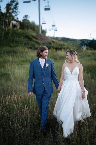 A groom glancing at his beautiful bride in Aspen, Colorado on their wedding day.  Photo taken by Kelly Elizabeth Photography the best wedding photographer in Aspen.