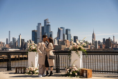 couples sharing a kiss with skyline view Styled by Yours Truly, a wedding planner and designer in New Jersey.