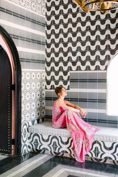 woman in pink beaded gown and black and white room