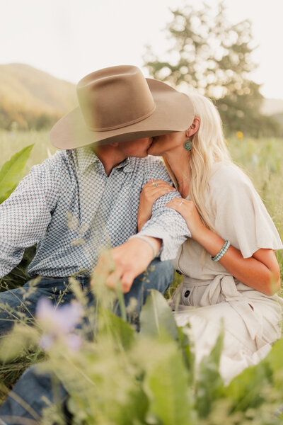 Couple kissing in the mountains for their engagement photos taken by Western Wedding Photographer