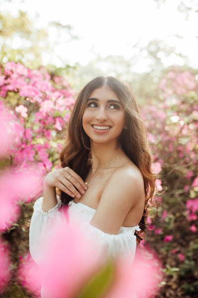 Senior poses in a flower garden