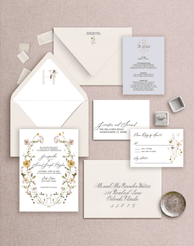 Flat lay of a blush and cream wedding invitation suite 