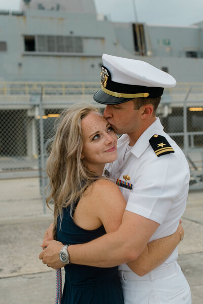 Navy military couple embrace after seven months apart
