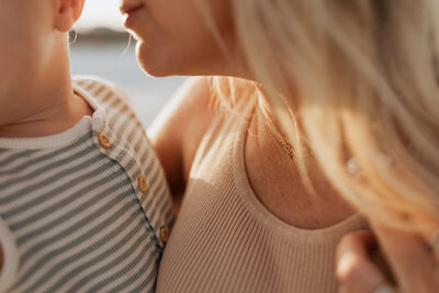 Closeup of mom going in to kiss her child