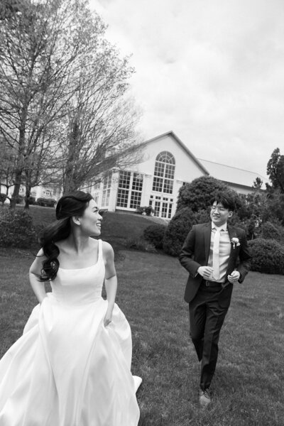 Bride and groom wedding photos chasing after each other outside of Raspberry Plain Manor venue in Leesburg, Virginia. 