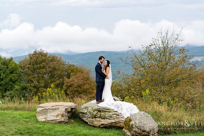 Bride and groom on rock at North Carolina destination wedding