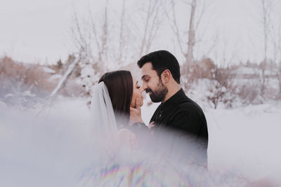 Reno wedding photography couple about to kiss in the snow crystal peak park