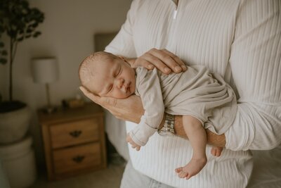 Dad holding newborn baby during Tacoma Newborn Photography session