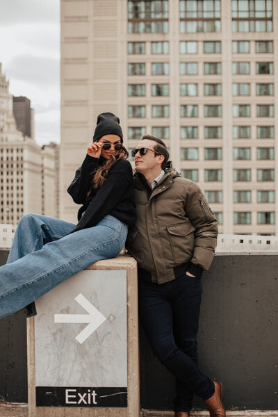 Engaged couple posing on a rooftop in Denver, CO