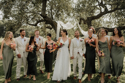 New England couple smiling with their bridal party