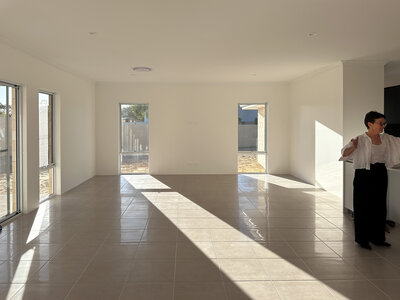 New home living with tiled floor and vertical windows