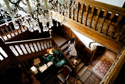 a bride walking down the stairs on her way to get married during her wedding at Berwick Lodge in bristol
