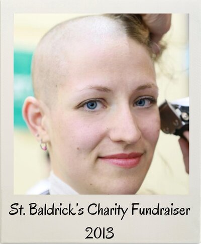 Jill Soper smiling during her head shave at a St. Baldrick’s Foundation charity fundraiser in 2013, captured in a Polaroid-style photo.