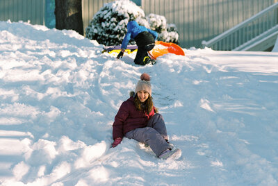 Children exploring a snowy backyard during a relaxed family photo session in the Hudson Valley