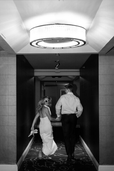 couple running. down hallway. in the. Logan Hotel Philly