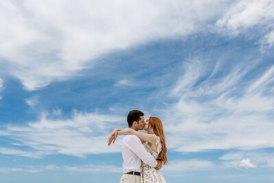 bride and groom hand in hand on beach