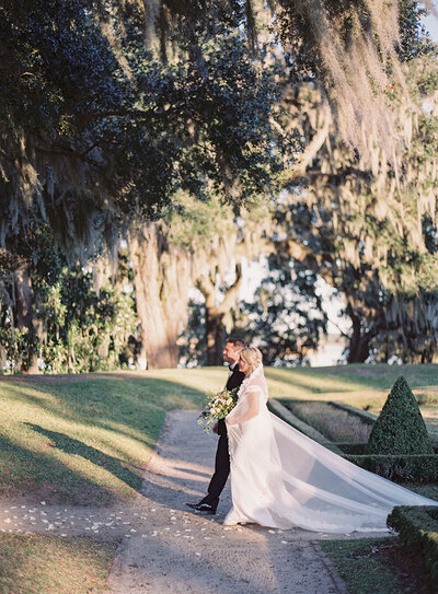 Father of the Bride walking his daughter down the aisle during an Octagonal Garden wedding ceremony at Middleton Place