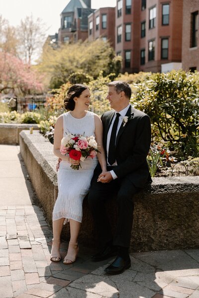 bride and groom smiling downtown boston