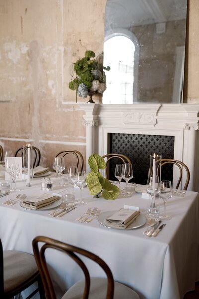 Romantic tablescape with hydrangeas and taper candles set inside Old Sessions House.