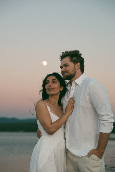Couple embracing in a sunlit kitchen on Vancouver Island, captured by Rae Terrillon Photography
