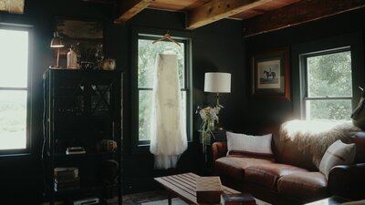 Danielle Frankel wedding gown hanging on a window.