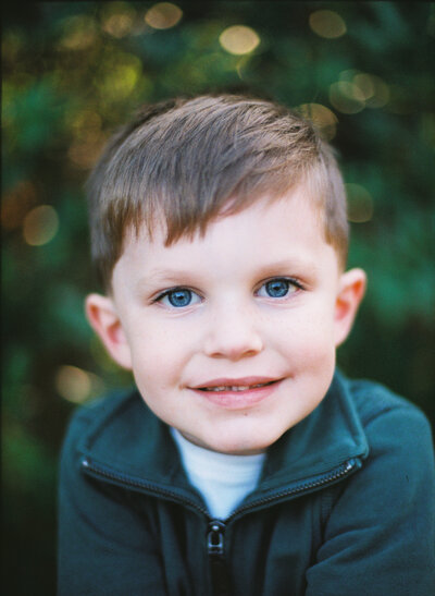 Small boy smiling into camera