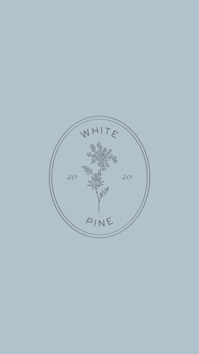 White Pine Designs stamp logo on light blue background