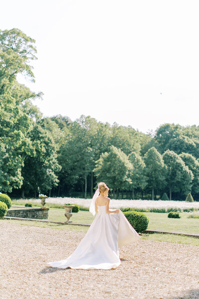 A bride looks at the camera in an elegant photograph by Beth Sheridan wedding photography.