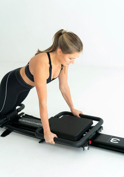 kylie practicing roll out form on reformer
