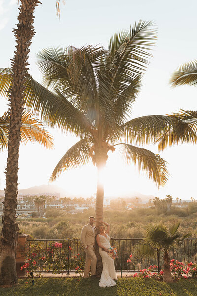 couple eloping in tropical setting near the palm trees