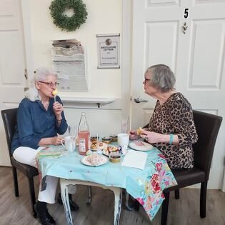 Senior citizens enjoying a meal together at assisted living home in Tri-Cities Washington
