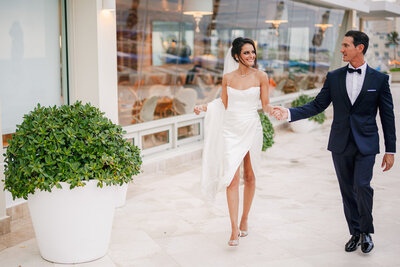 Bride and Groom walk hand in hand in the Condado Vanderbilt Puerto Rico