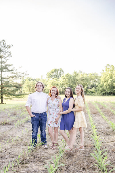 Mom and children in a field in Ohio standing and smiling at the camera.