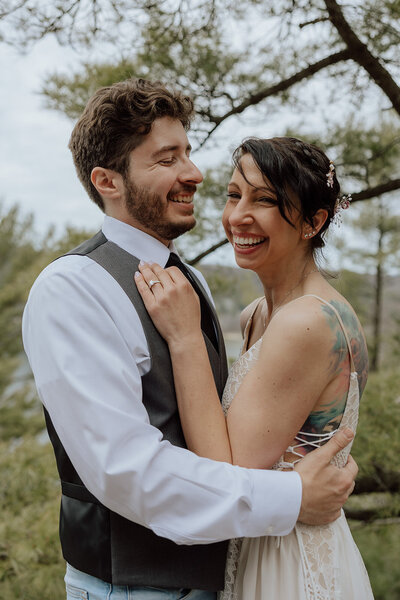 bride and groom embracing and laughing during their elopement