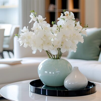 Modern coffee table with floral vase and soft lighting — represents access to free blog coaching videos, tutorials, and education for beginners
