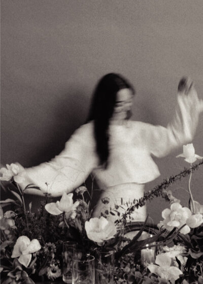 blurred image of woman with flower display