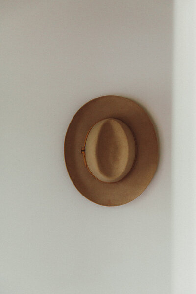 a hat hanging in a vintage shop in high falls, new york