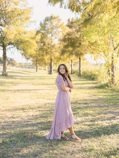 Celebrate this milestone with a stunning senior portrait session in the Texas Hill Country. Captured among beautiful trees, showcasing natural light and timeless elegance.