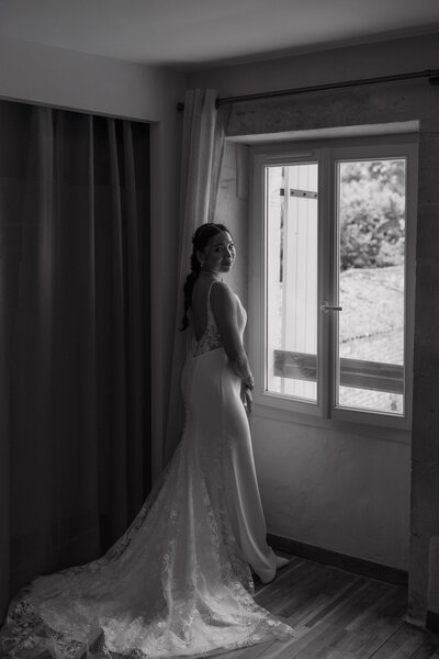 Wedding photographer captures couple taking a stroll hand in hand at their french chateau wedding.