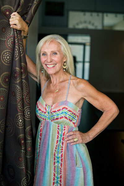 Personal branding photo of a mature blonde wellness coach posing in her health studio.