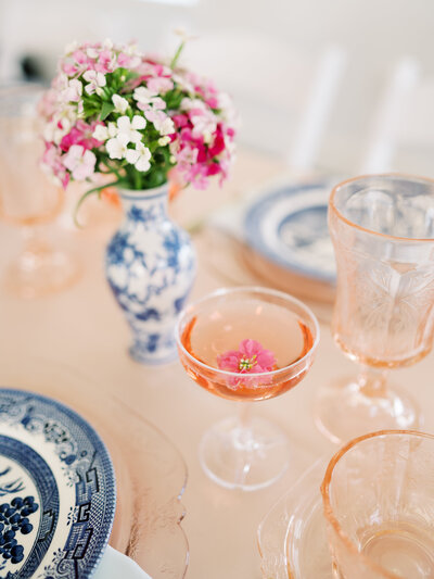A pink champagne glass on a table at a luxury wedding.
