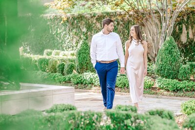 Engaged couple walking through museum garden | Birmingham Alabama engagement photographer Amanda Horne