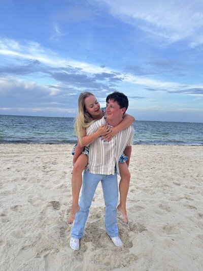 Gorgeous engaged couple on the beach, excited for their dream destination wedding