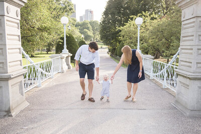 family holding hands at park by family photographer boston ma​
