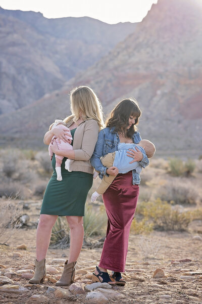 Two lactation experts, including Autumn Wake, standing outdoors while holding babies, promoting breastfeeding and lactation expertise.