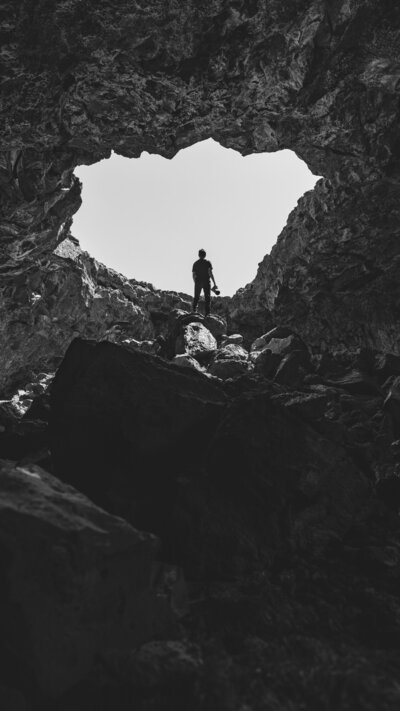 Man stands inside of rocky craters