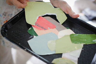 Closeup of Adele holding art on table