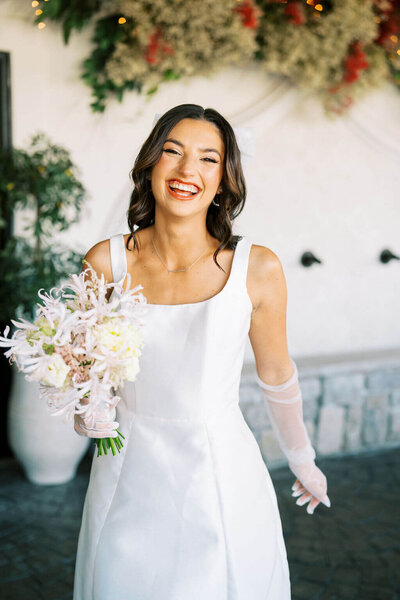 Bride holding bouquet of white florals designed by Jessamine floral and events